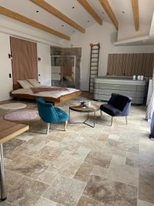 a room with a bed and a table and chairs at Love room in Paizay-le-Chapt