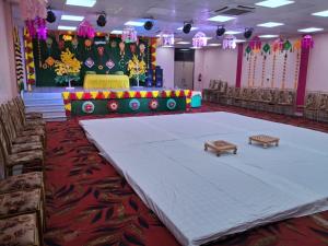 a large banquet hall with a table and benches at Kailash Haveli in Bikaner