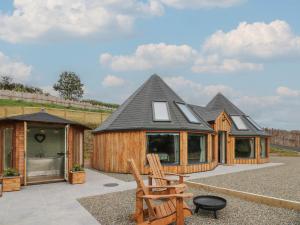 a group of wooden homes with a pitched roof at Y Cwlwm - The Celtic Knot in Lampeter