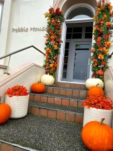 a group of pumpkins sitting on the steps of a house at Pebble House in Llandudno