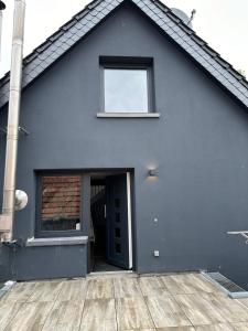 a black house with a door and a window at Fewo Snowdogs in Goch