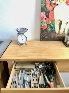 a drawer in a table with a clock and tools at 100 qm großes lichtdurchflutetes Loft im Herzen der City in Bochum