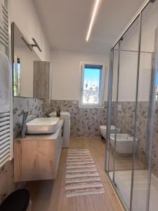 a bathroom with a tub and a sink and a shower at Casette Airport LILLY in Seriate +32 photos