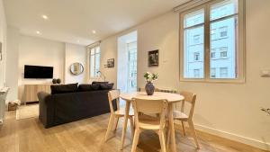 a living room with a table and a couch at CoruñaFlat Apartamentos con encanto en el centro de A Coruña in A Coruña