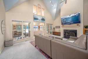 a living room with a large couch and a fireplace at Lake Days Getaway in Hillsborough