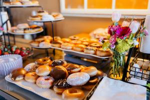 a display of different types of donuts on trays at Adriatic Residence in Budva +93 photos