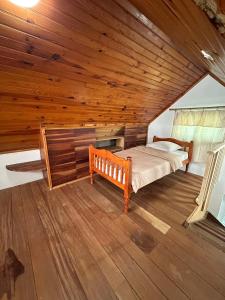 a bedroom with a bed and a wooden ceiling at Le Voile de la Mariée in Salazie +39 photos