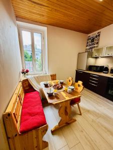 a kitchen with a wooden table in a room at T2 Hyper-centre Villard de lans, style chalet in Villard-de-Lans