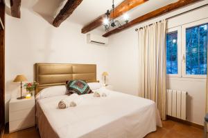 a bedroom with a bed with two towels on it at El Charco in Cala Llonga +17 photos