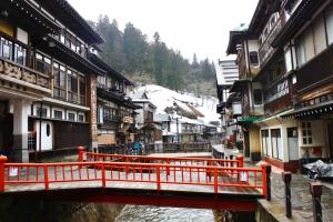 a bridge over a river in a town with buildings at Tomaru細野 in Nobezawa +5 photos