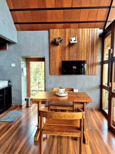 a dining room with a wooden table and chairs at Mount Lux Villa in Devāla