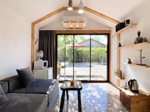 a living room with a couch and a table at Tiny House Nada Vineyard in Rakhat