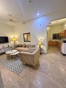 a living room with a couch and a table at Apartment in Karachi near airport in Karachi