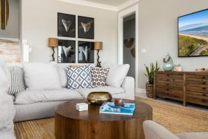 a living room with a couch and a coffee table at Casa Del Sol home in Stingaree +81 photos