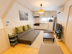 a living room with a couch and a kitchen at Ikebukuro-Otsuka-10min ShinOtsuka Sta-For families and groups-Switch-net-Mobile Wi-Fi in Tokyo