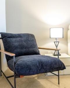 a blue chair in a room with a lamp at Echo Ridge home in Scottsdale