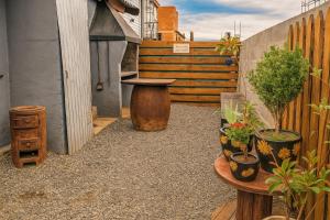 a small patio with a table and potted plants at Casa Rural Bella Zaira in El Calafate