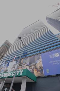 a large building with a sign on the side of it at Exclusive Sea View Aparthotel In Orbi City Batumi in Batumi