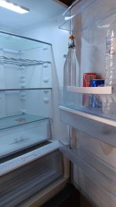 an open refrigerator with a bottle on the door at Adorable apartment in Athens