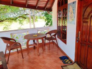 a porch with a table and chairs and a window at ANTONIO TRANSIT KATUNAYAKE in Katunayaka