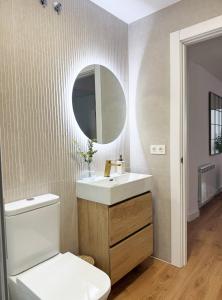 a bathroom with a toilet and a sink and a mirror at Megara Home in Soria