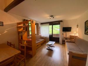 a living room with a couch and a bunk bed at Aigles 19 Bajeux Bât 2 in La Clusaz