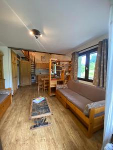 a living room with a couch and a table at Aigles 19 Bajeux Bât 2 in La Clusaz