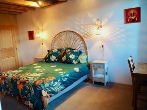 a bedroom with a bed and a table with a night stand at La Colonie d'Antan in Collonges