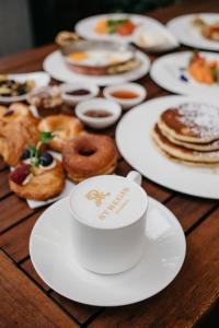 a table with white plates of pastries on it at The St. Regis Istanbul in Istanbul +184 photos