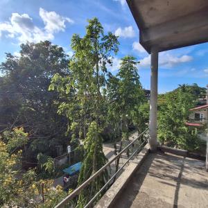 a view from the balcony of a house with trees at Atithi Homestay in Sivasagar