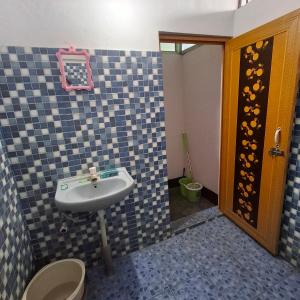 a bathroom with a sink and a toilet at Atithi Homestay in Sivasagar +18 photos