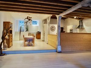 a kitchen and dining room with a table in a house at La Colonie d'Antan in Collonges