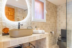 a bathroom with a sink and a mirror at Vistamar 96 in Benitachell +19 photos