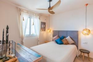 a bedroom with a bed and a ceiling fan at Vistamar 96 in Benitachell