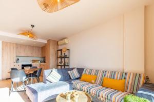 a living room with a couch and a table at Vistamar 96 in Benitachell