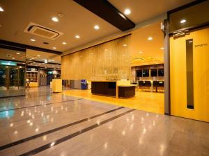 an empty lobby with a counter in a building at Super Hotel Minamata in Minamata