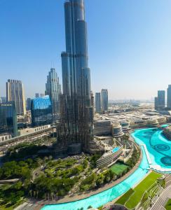 an aerial view of a city with a tall skyscraper at GRANDE RESIDENCES with a direct Burj Khalifa view and Private Fountain Show at 38th floor with DXB AIRPORT VIP Shuttle in Dubai