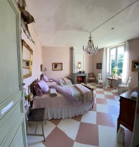 a bedroom with a bed and a checkered floor at Chateau Ciers in Saint-Ciers-sur-Gironde