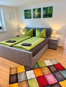 a bedroom with a large bed with a colorful rug at Ferienwohnung Dahoam² inkl. Chiemgaukarte in Ruhpolding