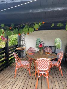 a patio with a table and chairs on a deck at Gunilla's house in Huaröd in Huaröd +71 photos
