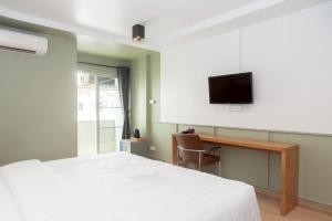 a bedroom with a bed and a desk and a tv at Quicky Stay Airport in Min Buri +31 photos