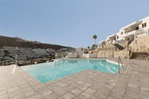 a large swimming pool in the middle of a building at Canarian Dream Sun and Peace in Puerto Rico de Gran Canaria