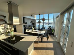 a kitchen and living room with a view of the ocean at House for 6 with Breathtaking Sea Views - 35 min from Gothenburg in Kärna