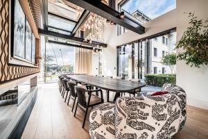 a dining room with a long table and chairs at Chateau De Neydens in Saint-Cergues