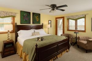 a bedroom with a bed and a ceiling fan at Hawk Valley Retreat & Cottages in Galena
