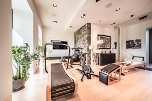 a gym with a treadmill and exercise equipment in a room at Chateau De Neydens in Saint-Cergues
