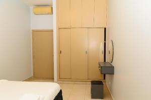 a room with a bed and a closet with a refrigerator at Spacious & bright bedroom in Dakar