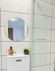 a bathroom with a sink and a mirror at Studio Sena - Disney - Meaux City Center - Paris in Meaux