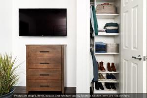 a closet with a television on a wall at InTown Suites Extended Stay Dothan AL in Dothan