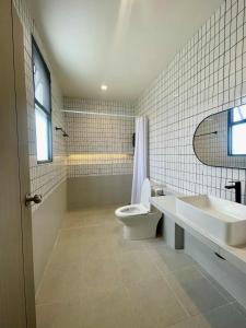 a white bathroom with a toilet and a sink at Cloud N Wind Khao Kho Thailand in Ban Lao Kok Kho